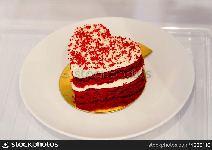 Heart shaped cake on dish.