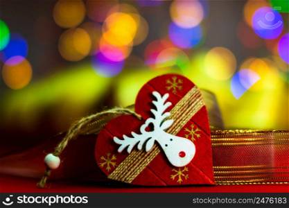 Heart shaped Christmas decoration isolated on blurred background of lights.