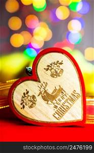 Heart shaped Christmas decoration isolated on blurred background of lights.