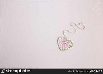 Heart-shaped cloth patch on white background.