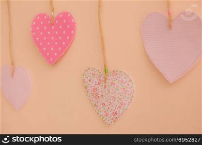 Heart-shaped cloth patches hanging on the wall.