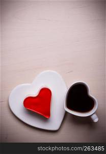 Heart shaped coffee cup and jelly cake on wooden surface, top view copy space for text