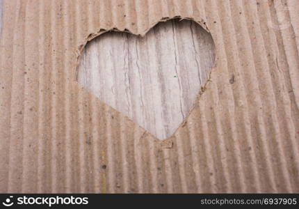 Heart shaped cut out of a brown cardboard