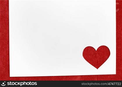 Heart shaped cut paper for Valenine's day greeting card on red craft background