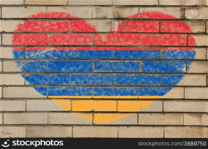 heart shaped flag in colors of armenia on brick wall