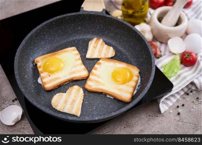 Heart shaped Fried Egg on Toast Bread in a pan at domestic kitchen.. Heart shaped Fried Egg on Toast Bread in a pan at domestic kitchen
