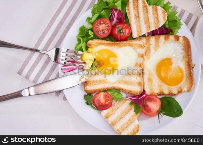 Heart Shaped Fried Egg on Toast Bread on light grey background.. Heart Shaped Fried Egg on Toast Bread on light grey background