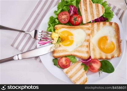 Heart Shaped Fried Egg on Toast Bread on light grey background.. Heart Shaped Fried Egg on Toast Bread on light grey background