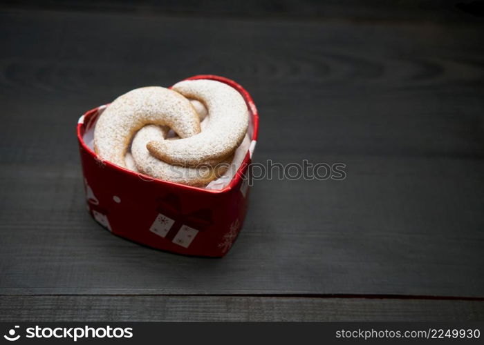 Heart shaped Gift box full of Traditional German or Austrian Vanillekipferl vanilla kipferl cookies. High quality photo. Heart shaped Gift box full of Traditional German or Austrian Vanillekipferl vanilla kipferl cookies