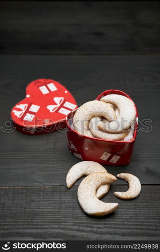 Heart shaped Gift box full of Traditional German or Austrian Vanillekipferl vanilla kipferl cookies. High quality photo. Heart shaped Gift box full of Traditional German or Austrian Vanillekipferl vanilla kipferl cookies