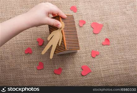 Heart shaped icons and paper house on canvas