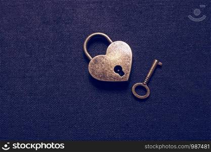 Heart shaped lock and key on an abstract background