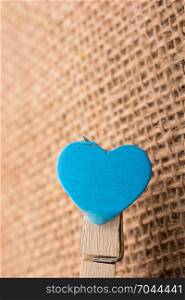 Heart shaped object on a blue clothes pin