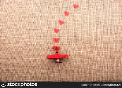 Heart shaped objects behind an airplane . Heart shaped objects behind an red model airplane