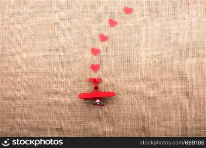 Heart shaped objects behind an red model airplane