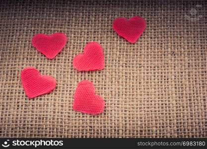Heart shaped objects on a linen canvas