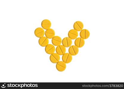 heart shaped of yellow medicine on the white background