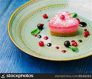 heart shaped raw vegan red cake with raspberries