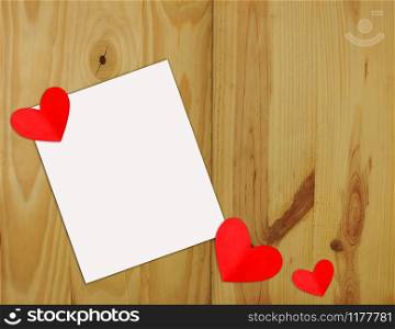 Heart shaped red paper on white paper on a wooden background Valentine?s Day