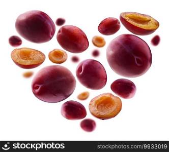 Heart shaped red plums on white background.. Heart shaped red plums on white background