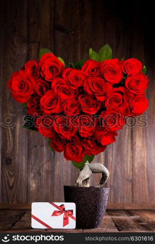 Heart shaped roses. Heart shaped red roses on tree and gift box