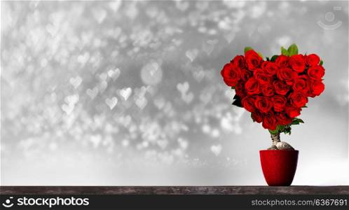 Heart shaped roses. Heart shaped red roses on tree on bokeh hearts background