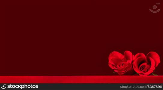 Heart shaped roses. Two heart shaped red roses on fabric, background with copy space, Valentines day