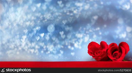 Heart shaped roses. Two heart shaped red roses on glowing bokeh lights background