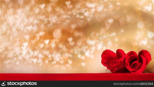 Heart shaped roses. Two heart shaped red roses on golden glowing bokeh hearts background for Valentines day