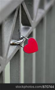 heart shaped safety lock on a bridge railing sign of love
