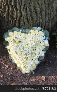 Heart shaped sympathy flower arrangement with white flowers