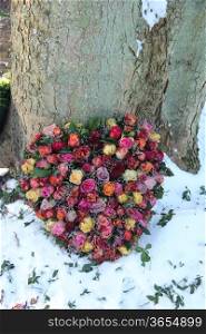 Heart shaped sympathy flowers in the snow