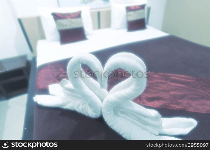 Heart-shaped towels on the bed, Valentine&rsquo;s Day concept, vintage filter image
