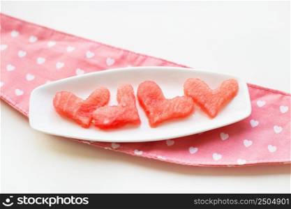 heart-shaped watermelon on a plate top view. watermelon on a white plate