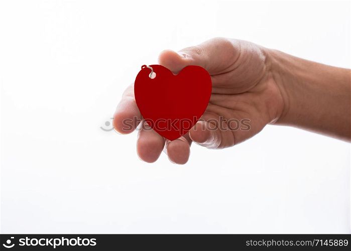 Heart shaped white object in hand on white background