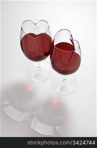 Heart shaped wine glasses filled with love poison (love, valentine day series; 3d isolated objects)