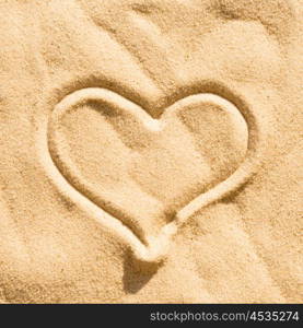 Heart sign drawing on the beach sand