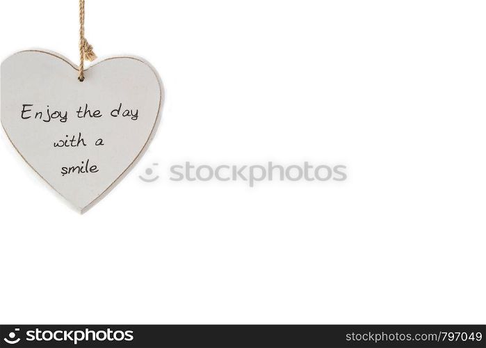 Heart sign with the saying enjoy the day with a smile on wood, isolated on white background, romantic. Heart sign with the saying enjoy the day with a smile on wood, isolated on white background