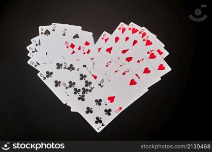 heart symbol made of playing cards dark reflective background.. heart symbol made of playing cards dark reflective background
