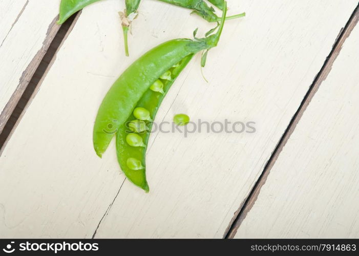 hearthy fresh green peas over a rustic wood table