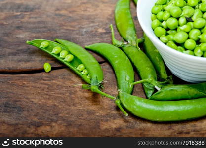 hearthy fresh green peas over a rustic wood table