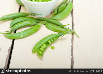 hearthy fresh green peas over a rustic wood table