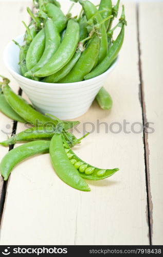 hearthy fresh green peas over a rustic wood table