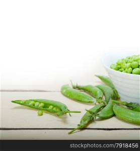 hearthy fresh green peas over a rustic wood table