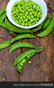 hearthy fresh green peas over a rustic wood table