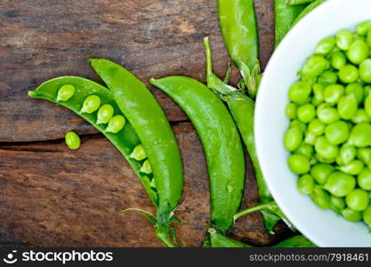 hearthy fresh green peas over a rustic wood table