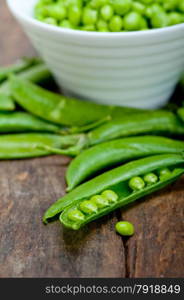 hearthy fresh green peas over a rustic wood table