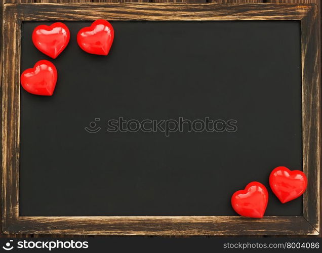 hearts and blackboard on the wooden background