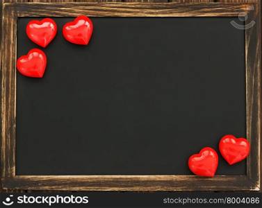 hearts and blackboard on the wooden background