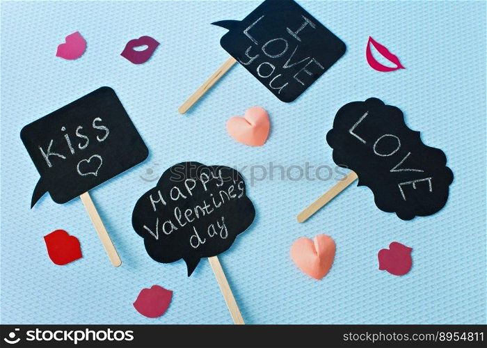 Hearts and lips on a blue background. Valentine’s Day. Valentines day greeting card. An offer of marriage. Engagement. Flatly. Plates with words.. Hearts and lips on a blue background. Valentine’s Day. Valentines day greeting card. An offer of marriage. Engagement. Flatly. Plates with words